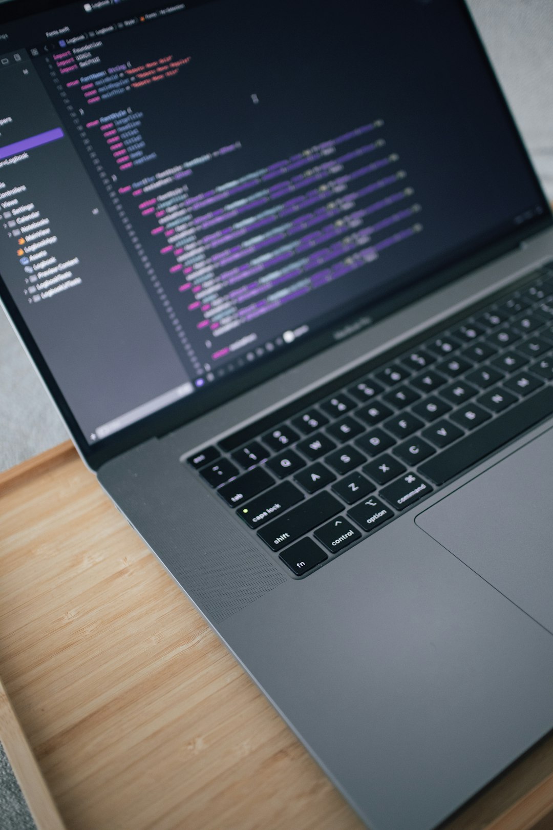 a-laptop-computer-sitting-on-top-of-a-wooden-desk-wt586uqxwl8