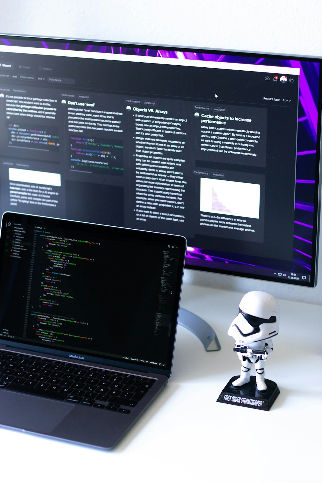 about-04 Beautiful and clean white desk with a purple desktop and a space-grey MacBook Air